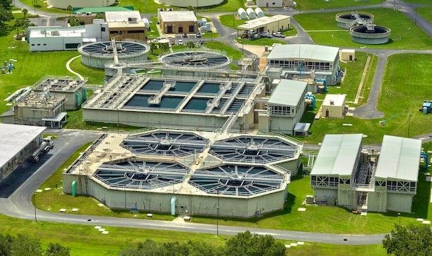 A detailed close-up of a manufacturing facility's wastewater treatment system, showcasing advanced filtration and monitoring equipment. The focus is on the technology implementation required for compliance with new water pollution standards.