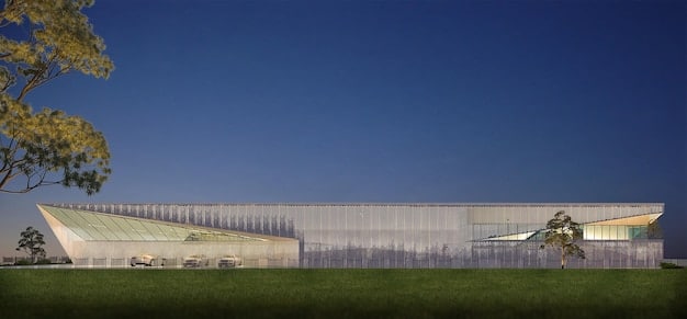 A US manufacturing plant exterior showcasing modern architecture with green spaces and visible sustainability features like rainwater harvesting systems and electric vehicle charging stations. The image emphasizes a forward-thinking, eco-friendly approach to manufacturing.