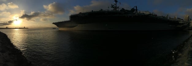 A split image showing a US Navy ship and a Chinese Navy ship side-by-side during a joint maritime exercise in international waters. This juxtaposition highlights the increasing presence of both countries' naval forces and the potential for cooperation or competition in the region.