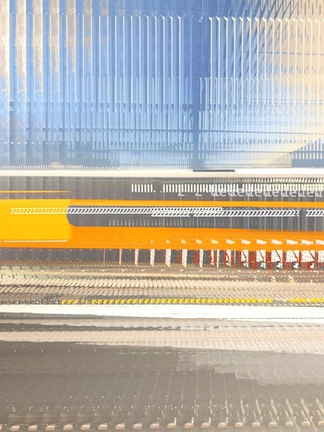 A split image showing a Chinese-built infrastructure project (e.g., a railway) on one side and a US-funded development project (e.g., a school) on the other, highlighting the competition for influence in Africa.