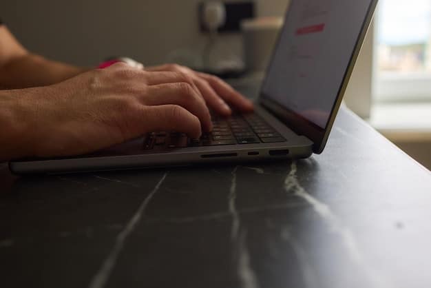 A close-up shot of hands typing on a laptop, with a focus on the screen displaying language learning software. The setting is a community college lab, symbolizing the role of technology in bridging language barriers for immigrant workers.