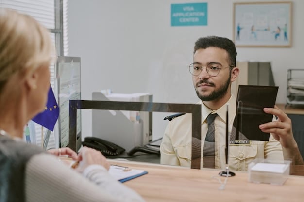 A smiling foreign worker receiving their Green Card from a USCIS officer in a modern office setting.