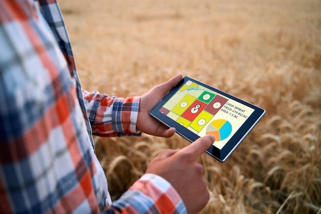 A close-up of a farmer using a tablet in a tractor, displaying a map of the field with color-coded zones indicating different nutrient levels.