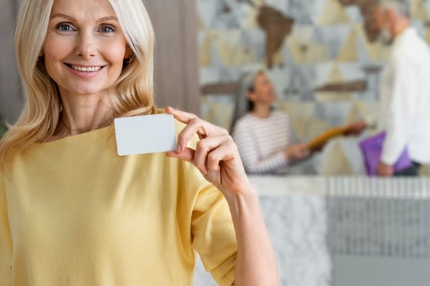 A close-up shot of a senior woman happily presenting her senior discount card while checking into a hotel. The focus is on her smile and the friendly interaction with the hotel staff.