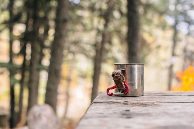 A close-up shot of a bear-resistant food storage container in a wooded campsite, with surrounding trees marked with bear warning signs. A tent is set up in the background.
