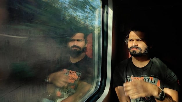 A person sitting comfortably in a train seat, gazing out the window at the passing scenery. The train interior is clean and modern, with ample legroom.