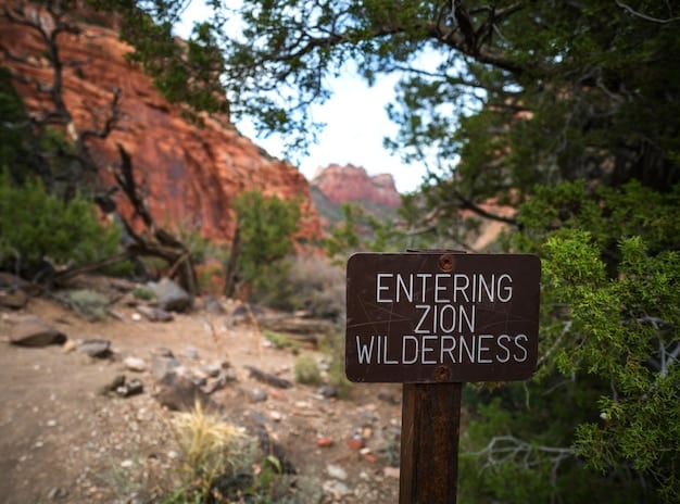 A photograph of a closed national park entrance with a sign indicating that it is closed due to the government shutdown. People are visible in the background, looking disappointed, highlighting the direct impact on tourism.