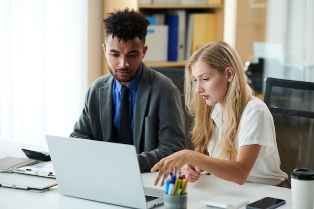 A university academic advisor meeting with a student in an office setting, reviewing course options on a computer screen and discussing career pathways.