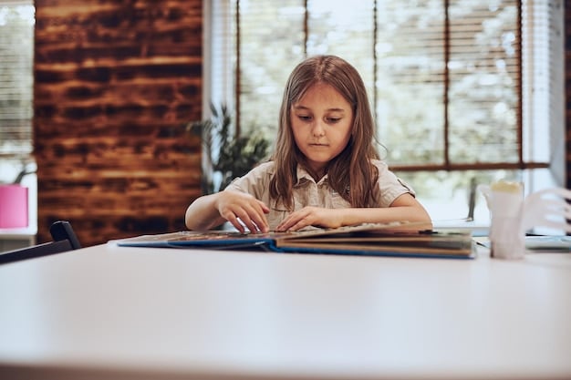A young girl sitting at a desk in a classroom, focused on reading a book with colorful illustrations. She is surrounded by educational materials like maps, globes, and posters. The scene captures her engagement and focus on learning.