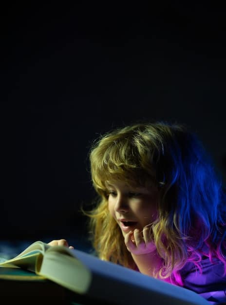A close-up of a child's hands using colored translucent overlays on a book while reading. The child appears focused, and the overlays are various colors, indicating a method to help with dyslexia.