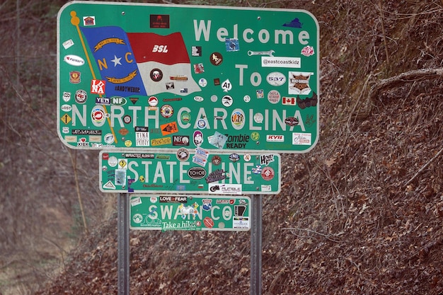 A collage showing various entrance signs of different US National Parks, highlighting the diversity of included locations. The signs include recognizable park names such as Yellowstone, Yosemite, and Acadia.