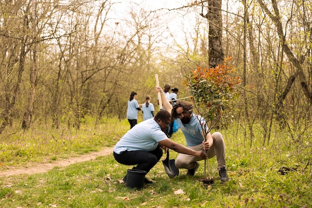 A group of volunteers planting trees in a national park, with a ranger supervising. The image should emphasize community involvement and environmental conservation.